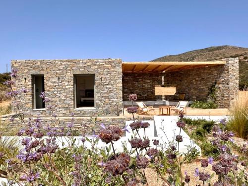 a stone house with a garden in front of it at Egeo Paros in Kampos Paros