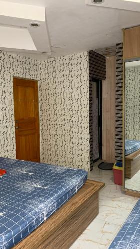 a bedroom with a bed and a wall with a door at Cabongaoan Beach, Burgos, Pangasinan 