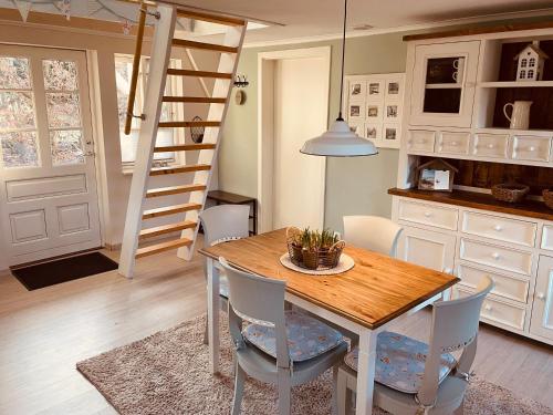 a kitchen with a table and chairs and a ladder at Ferienhaus Emma in Langelsheim