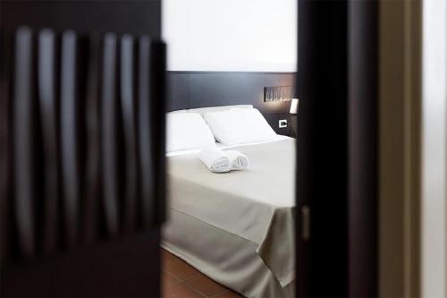 Ένα ή περισσότερα κρεβάτια σε δωμάτιο στο MC Hotel