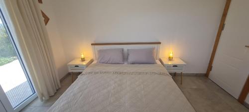 a bedroom with a large bed with two night stands at Sunrise Lodge Dapčevići - Montenegro in Dapčevići