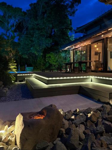 a backyard with a fire pit and a house at IGUANA Villa COSTA LATINA IWAI BEACH イグアナヴィラ in Wada