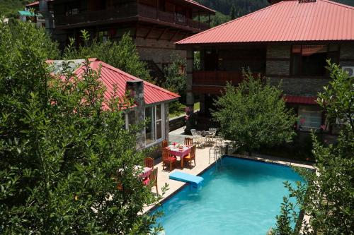 an overhead view of a swimming pool in front of a house at Shivadya - A Luxury Boutique Experience in Manāli