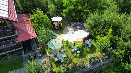 an overhead view of a garden with tables and umbrellas at Shivadya - A Luxury Boutique Experience in Manāli