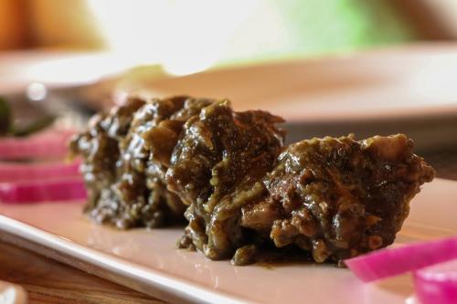 two pieces of food on a plate on a table at Shivadya - A Luxury Boutique Experience in Manāli