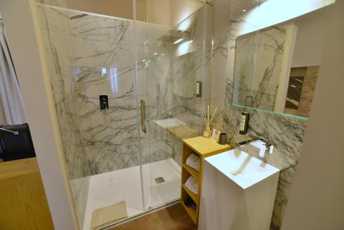a bathroom with a shower and a sink at Rooms in Spello in Spello
