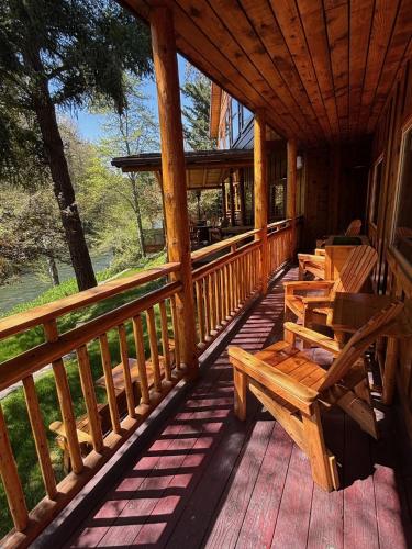 a porch of a cabin with benches on it at The Lindsay Lodge in Applegate