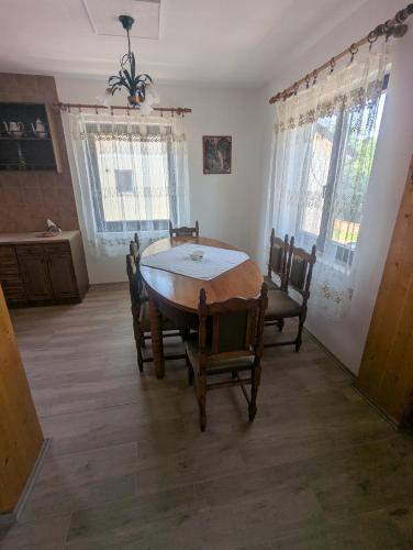 a dining room with a wooden table and chairs at Apartment In Pinosava in Pinosava