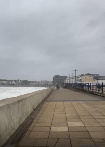 a view of the beach from the pier at Family & friends get together birthday hot tub in Porthcawl