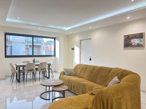 a living room with a couch and a table at Relax in Praia in comfort in Praia