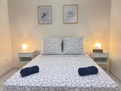 a bedroom with a bed with two pillows on it at Relax in Praia in comfort in Praia