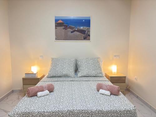 a bedroom with a bed with two lamps on it at Relax in Praia in comfort in Praia