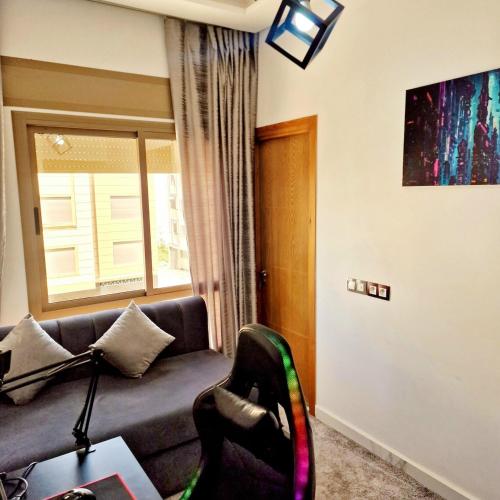 a living room with a couch and a window at Luxury apartment in Martil in Martil