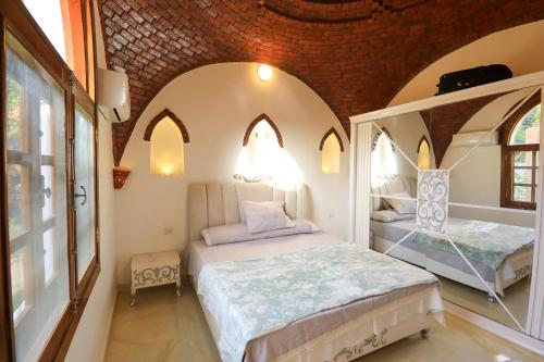 a bedroom with two beds in a room at Desert Rose apartment's in Luxor