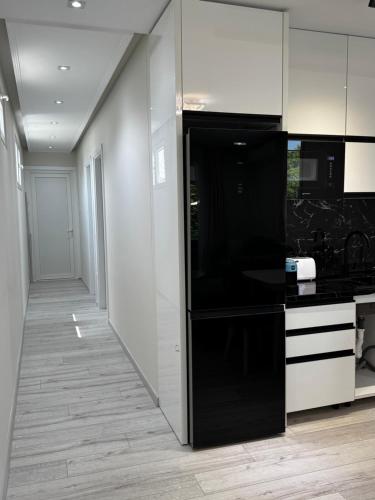 a kitchen with a large black and white refrigerator at Eron Villas Velipoje in Velipojë