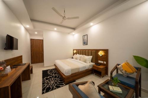 a bedroom with a bed and a living room at Perfectstayz Premium Mystic falls with Rooftop Pool & Cafe in Narendranagar