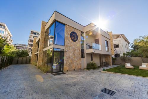 a large building with the sun shining behind it at Zoe's Villa by PS in Durrës