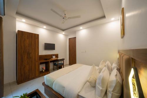a bedroom with a large bed and a desk at Perfectstayz Premium Mystic falls with Rooftop Pool & Cafe in Narendranagar