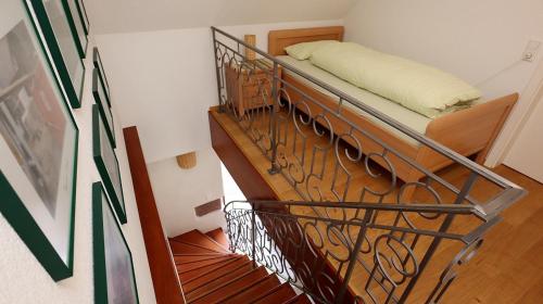 a bedroom with a bunk bed with a metal railing at Ferienhaus-Winzerhaus Sasbach in Sasbach am Kaiserstuhl
