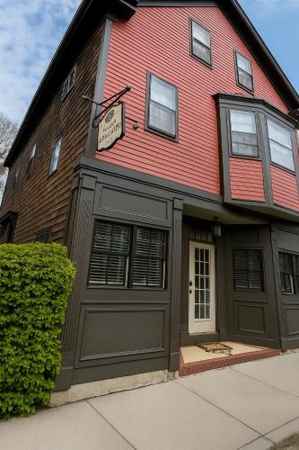 a red house with a garage with a sign on it at 86 Dr Marcus House - Popular Broadway Area in Newport
