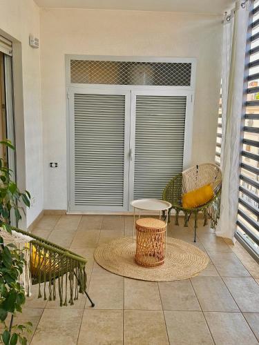 a room with a patio with a table and chairs at Aptments2 - real estate solutions in Olbia