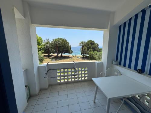 a balcony with a table and a view of the ocean at Mikri elia beach in Lagomandra