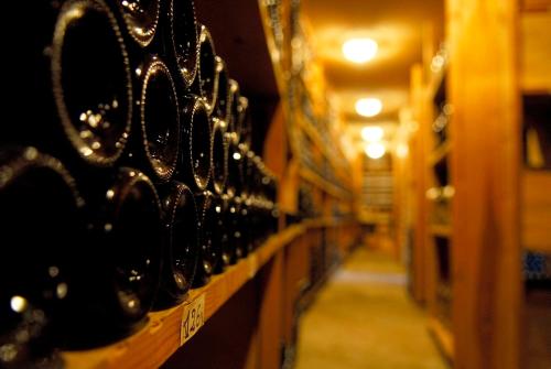 a row of wine racks in a wine cellar at Logis Hôtel - Restaurant Maison Claude Darroze in Langon