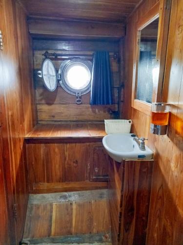 a small bathroom with a sink and a window at Sumba Ocean in Labuan Bajo