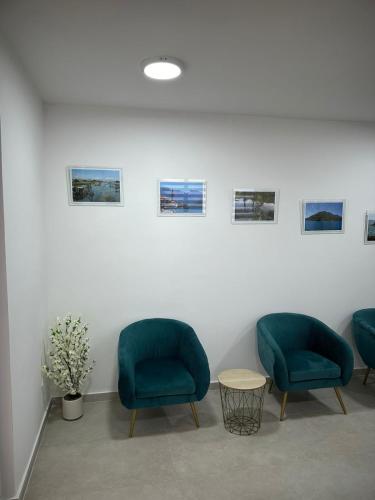 two blue chairs and a table in a room at Hotel Mondo in Budva