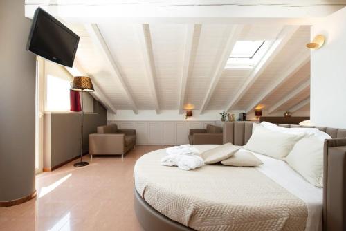 a bedroom with a bed and a tv on a ceiling at Hotel Lady Mary in Milano Marittima