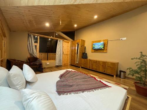 a bedroom with a large bed in a room at Rustic Roots Home Stay in Nagar