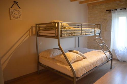 Ce lit superposé se trouve dans un dortoir doté d'un escalier. dans l'établissement Bienvenue A la Grange de Tatie 4 chambres, à Courbiac