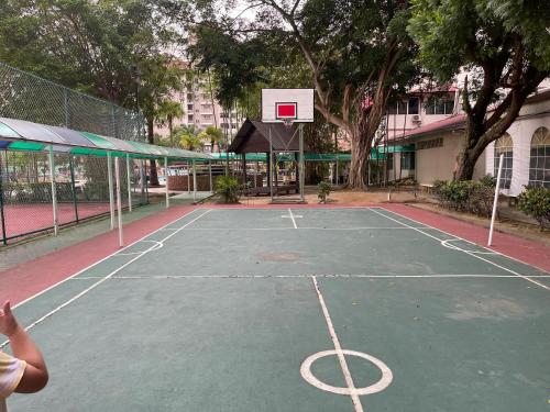 a tennis court with a basketball hoop on it at Private,Glory Beach Resort port dickson-negeri sembilan in Port Dickson