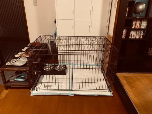 a metal bird cage with shoes in a room at 1日1組限定 5LDKお洒落古民家 駐車場2台 夜景を望む宿 "一休庵" Traditional house with yard and parking in Hiroshima
