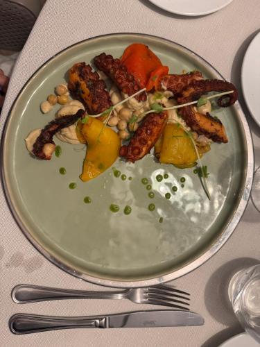 a plate of food with meat and vegetables on a table at L'ARCO E' DI FIO in Camaiore