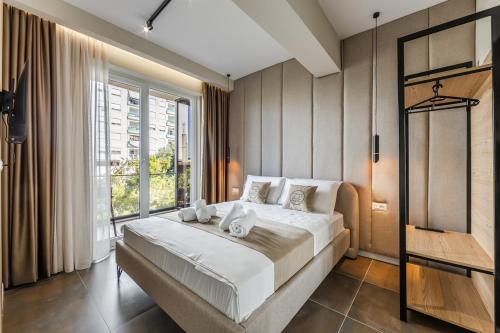 a bedroom with a large bed and a window at Zoe's Villa by PS in Durrës