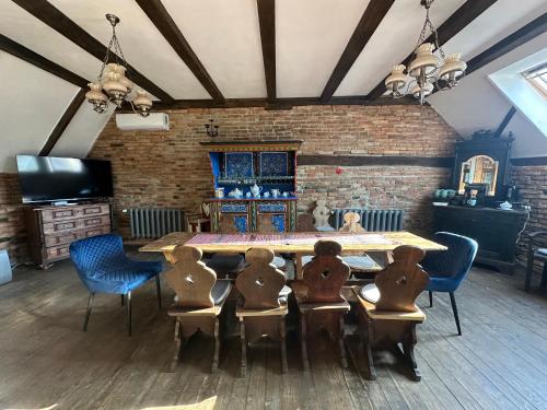 a dining room with a large table and chairs at Castle View Saschiz - Traditional Guesthouse in Saschiz
