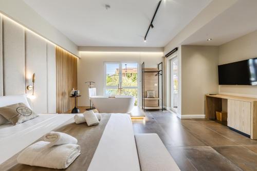 a bedroom with a large bed with a tub and a television at Zoe's Villa by PS in Durrës