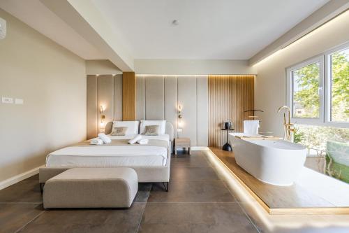 a hotel room with two beds and a bathtub at Zoe's Villa by PS in Durrës