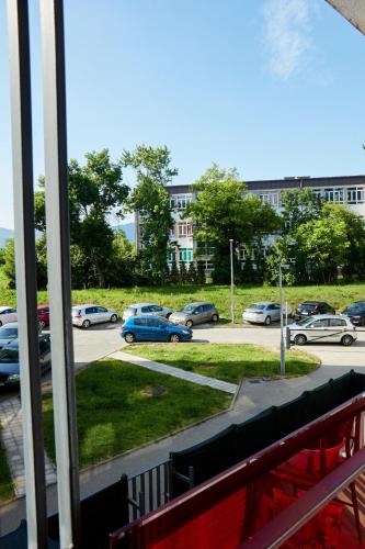 a view of a parking lot with cars parked at Lovely and cozy apartment Lena in Zenica