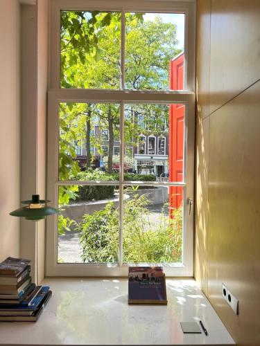 a window in a room with a book on a table at LE GARAGE Downtown serviced apartment in The Hague