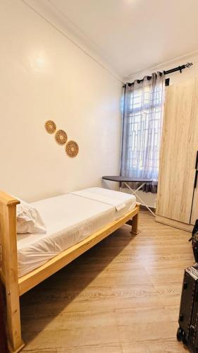 a bedroom with a wooden bed in a room at Zaya Residency in Kampala