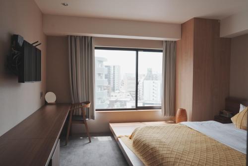 Postel nebo postele na pokoji v ubytování ICHIYU HOTEL ASAKUSA