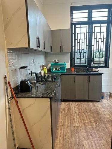 a kitchen with a sink and a counter top at Zaya Residency in Kampala
