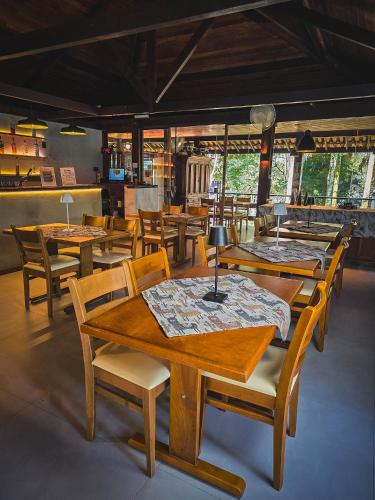 a dining room with wooden tables and chairs at Pousada Conde Redondo in Lumiar