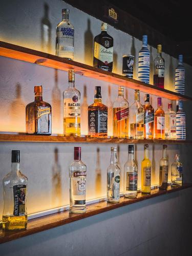 a shelf filled with lots of bottles of whiskey at Pousada Conde Redondo in Lumiar