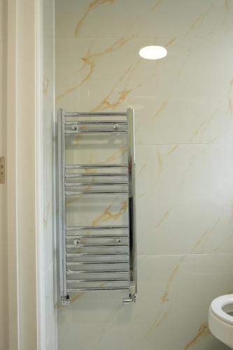 a bathroom with a towel rack next to a toilet at Cosy Getaway near beach in Southend-on-Sea