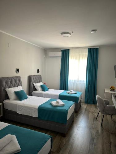 a hotel room with two beds and a window at Hotel Mondo in Budva