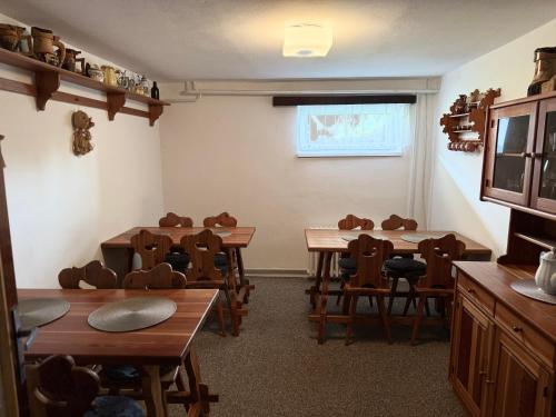 a classroom with tables and chairs in a room at Pension Burger in Harrachov