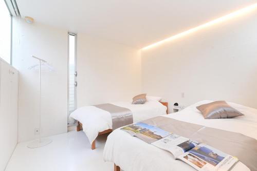 Cama o camas de una habitación en LOISIR Tateyama